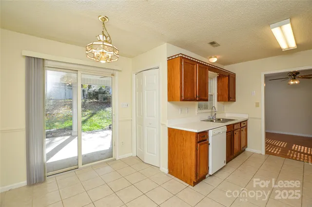 a kitchen with stainless steel appliances granite countertop a stove and a sink