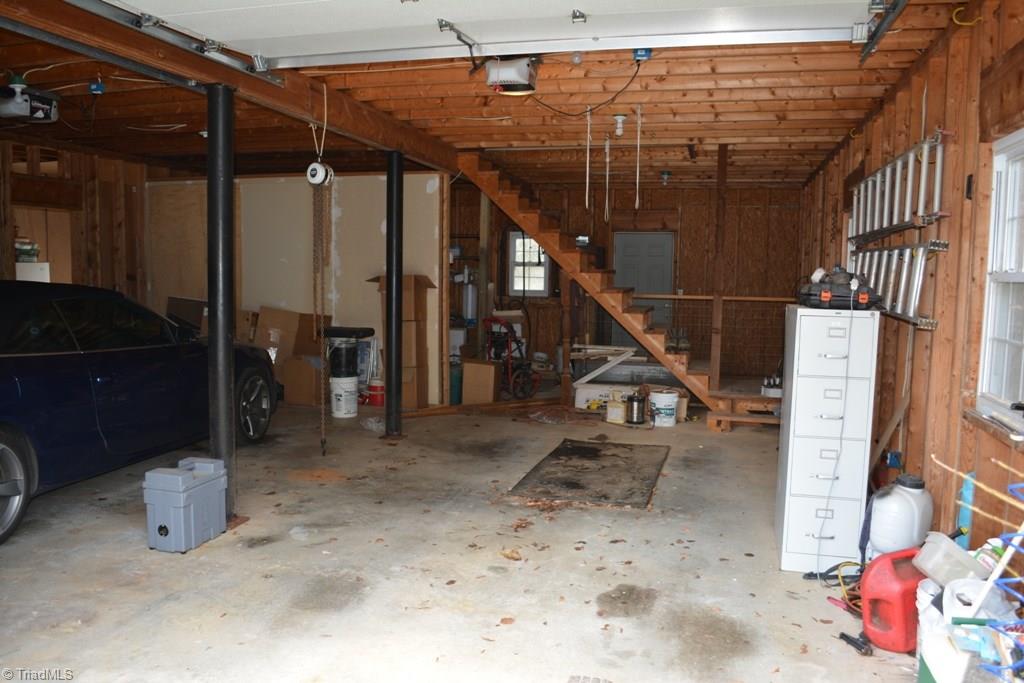 390 Mitchell Ridge Road Elkin, NC 28621 - Photo 14 of 20 Over sized, attached 2 car garage. The garage is very deep, and allows room for a shop/storage/craft/etc area in front of the cars.