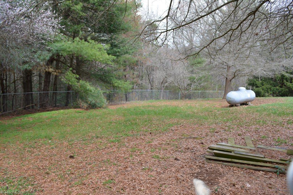 390 Mitchell Ridge Road Elkin, NC 28621 - Photo 16 of 20 Large, private back yard is fully fenced with chain link to keep the pets secure!