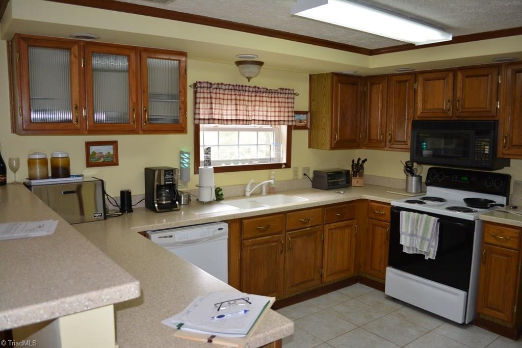 390 Mitchell Ridge Road Elkin, NC 28621 - Photo 5 of 20 Kitchen features Corian counter tops, nice cabinets and tile floor!