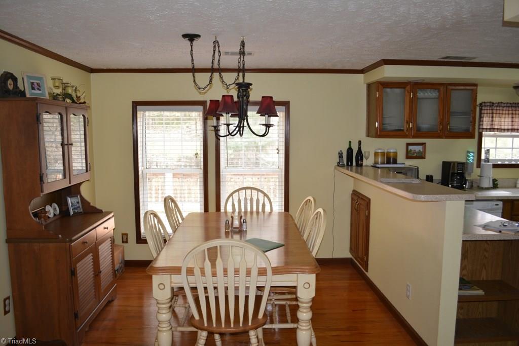 390 Mitchell Ridge Road Elkin, NC 28621 - Photo 6 of 20 Dining area has hardwood flooring and nice big windows that look out on the back deck.