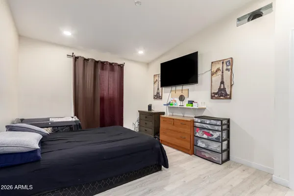 a bedroom with a bed and a flat screen tv