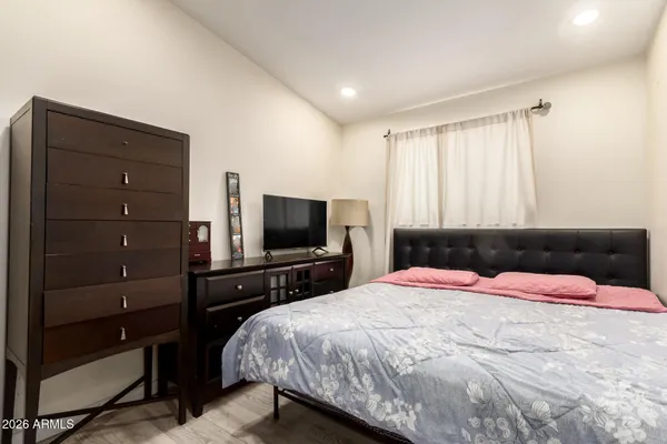 a bedroom with a bed and a flat screen tv