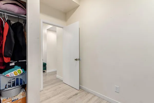 a view of walk in closet with clothes and shoes