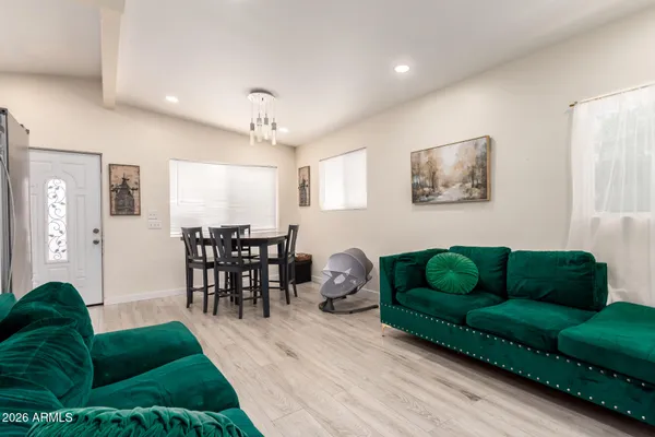 a living room with furniture and a dining room