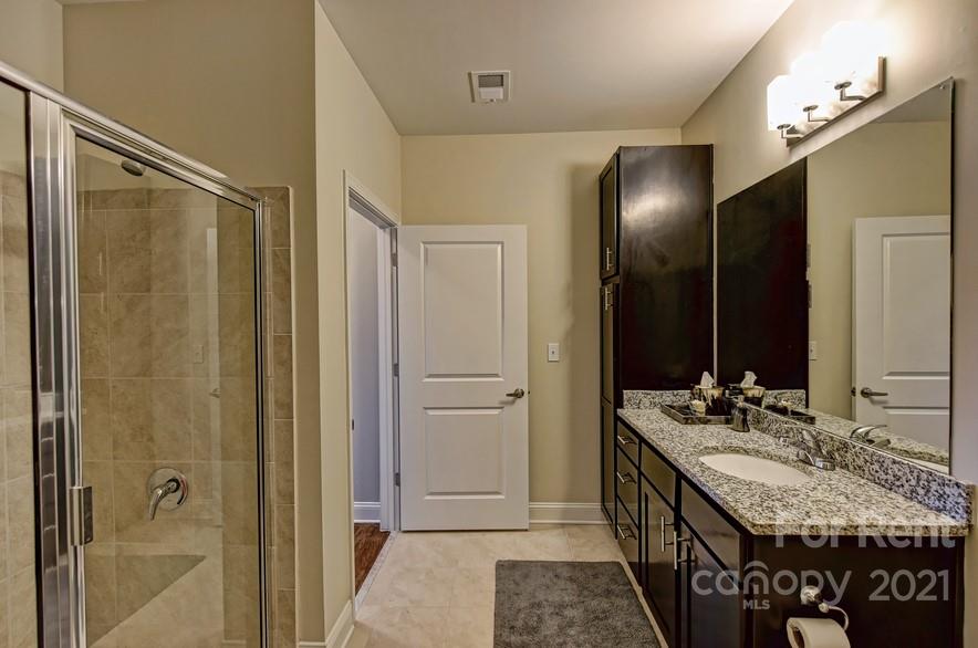 703 Rollerton Road Charlotte, NC 28205 - Photo 16 of 27 a bathroom with a double vanity sink and a mirror