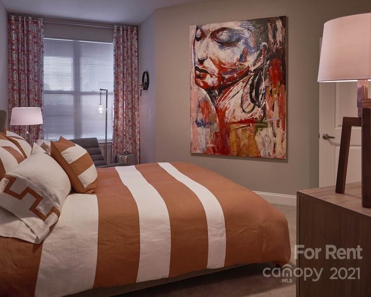 703 Rollerton Road Charlotte, NC 28205 - Photo 24 of 27 a bedroom with a bed and a painting on the wall
