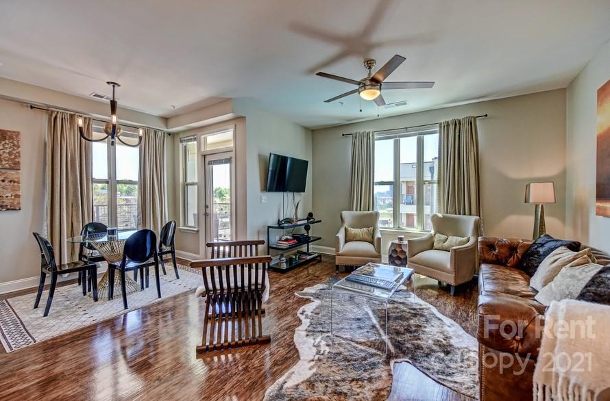 703 Rollerton Road Charlotte, NC 28205 - Photo 5 of 27 a living room with furniture wooden floor and a chandelier