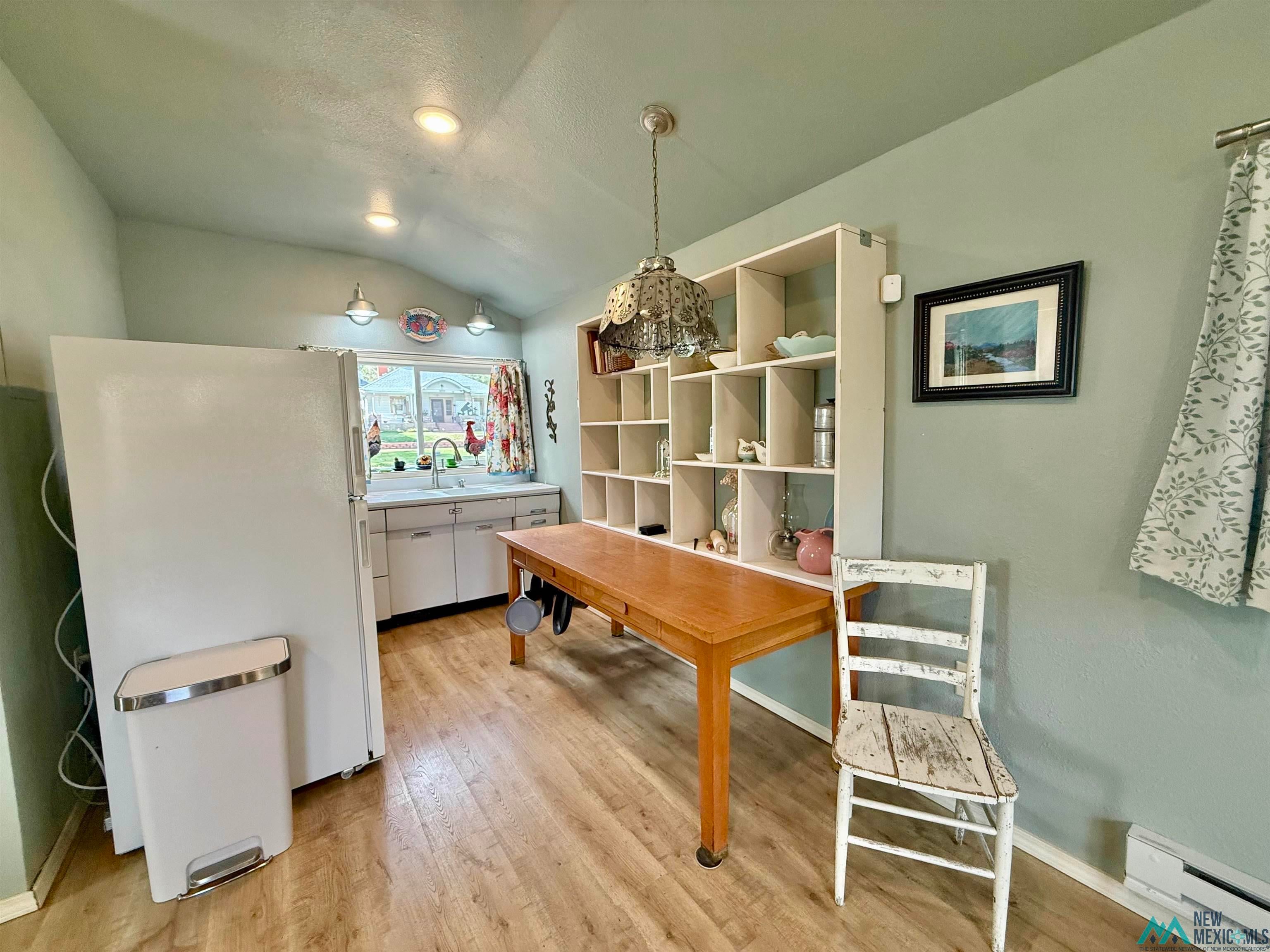 625 South 5th Street Raton, NM 87740 - Photo 35 of 45 Dining area with light wood-style floors, vaulted ceiling, and baseboard heating