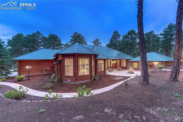 15975 Winding Trail Road Colorado Springs, CO 80908 - Photo 37 of 50 Walkway leads around from the driveway to the backyard paradise