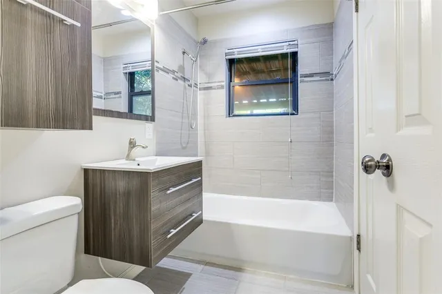 a bathroom with a sink a toilet and bathtub