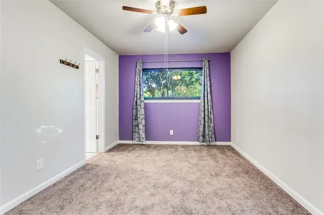 a view of room with window and ceiling fan