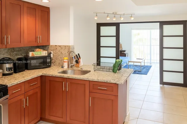 a kitchen with a sink cabinets and window