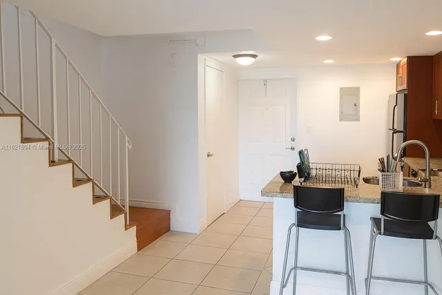 a view of kitchen with furniture and refrigerator