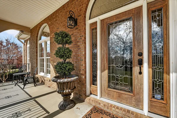 a view of dining room with wooden floor a chandelier a wooden table and chairs
