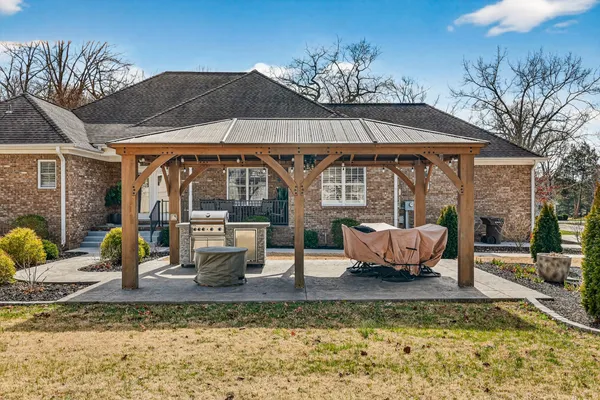 a view of a house with a yard patio and a garden