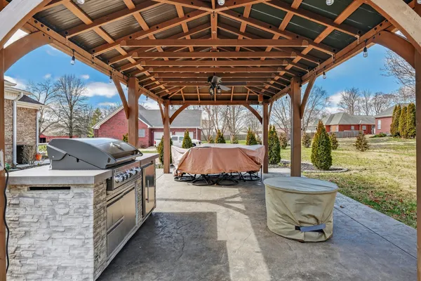 a front view of a house with swimming pool and furniture