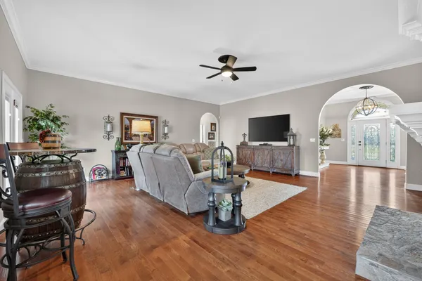 a living room with furniture fireplace and a window