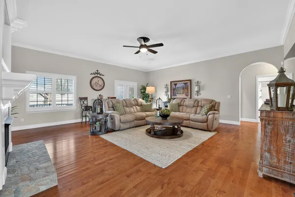a living room with fireplace furniture and a wooden floor