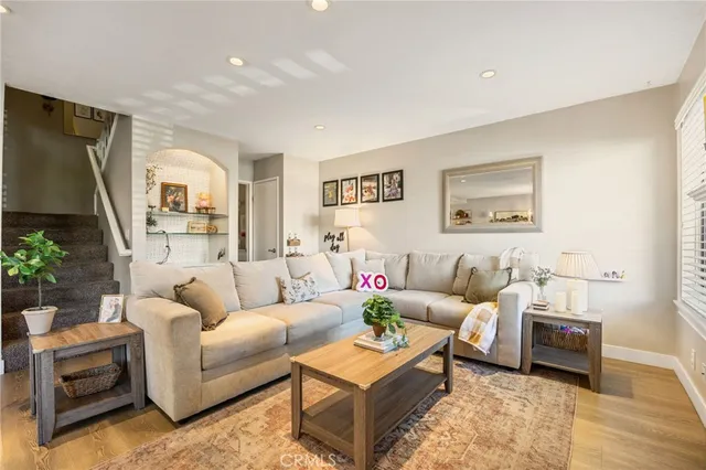 a living room with furniture and a painting on the wall