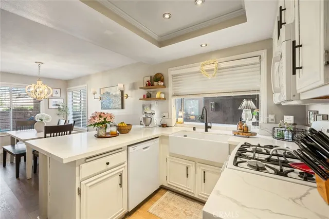 a kitchen with sink stove and cabinets