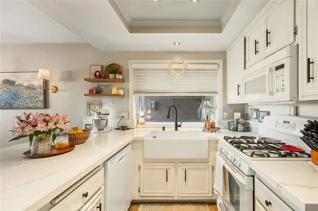 a kitchen with a sink cabinets and appliances