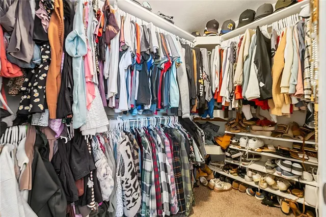 a view of walk in closet with clothes