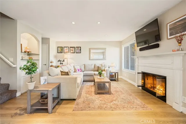 a living room with furniture a fireplace and a flat screen tv