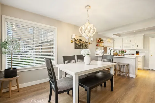 a view of a dining room with furniture wooden floor and chandelier