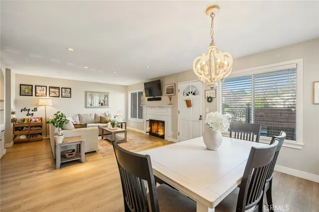 a view of a dining room with furniture wooden floor and chandelier