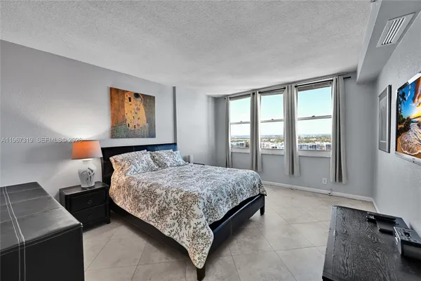 a bedroom with a bed and a night stand