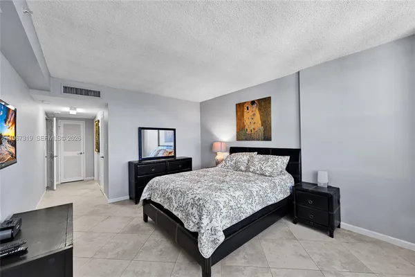 a bedroom with a bed and dresser