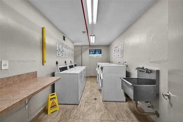 a room with a sink a washer and dryer