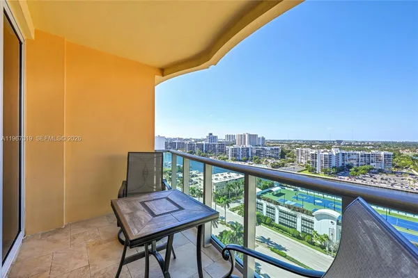 a view of a city from a balcony with furniture