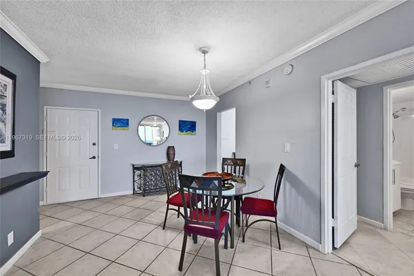 a dining room with furniture a chandelier and window