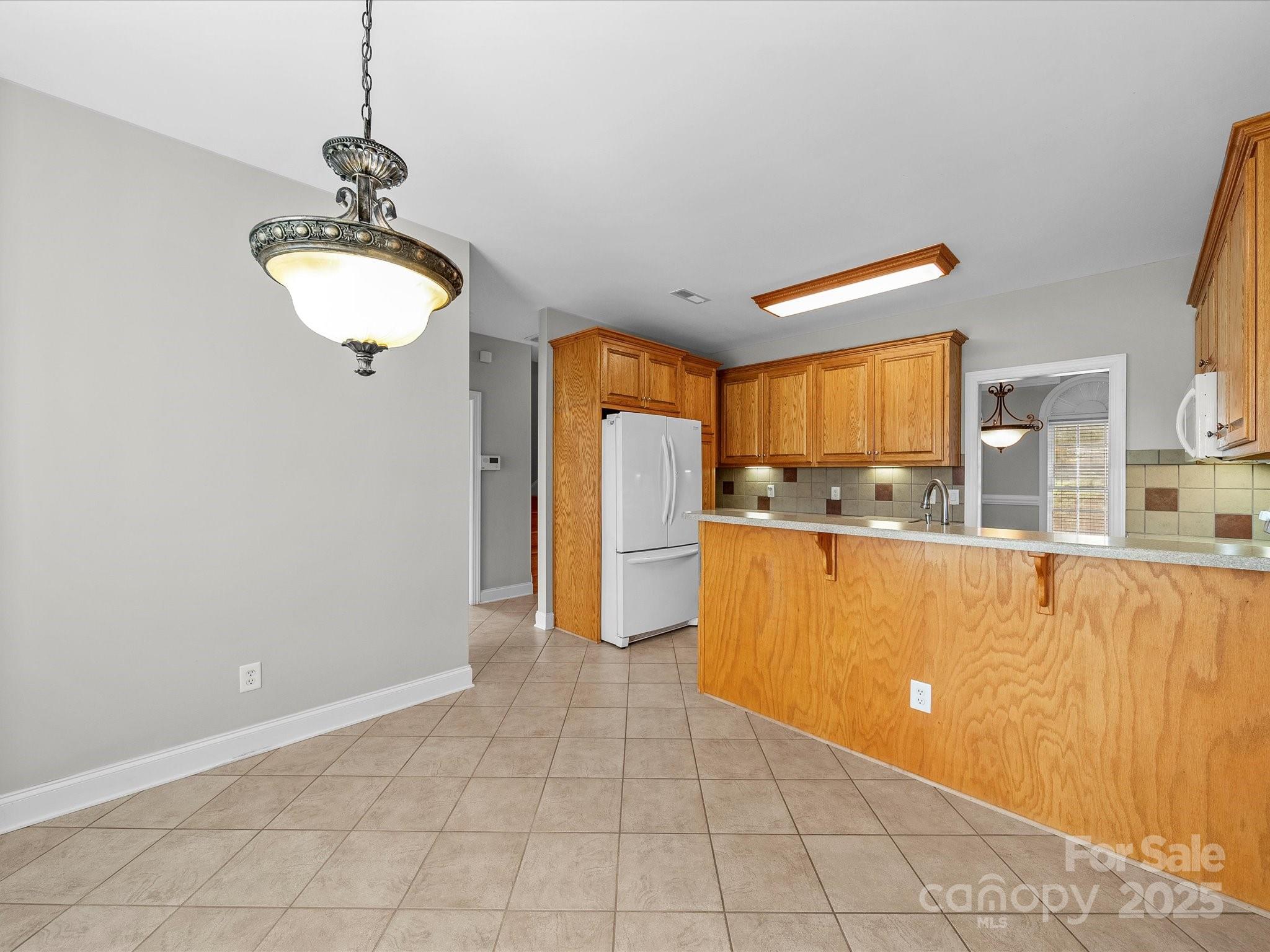 514 Clover Leaf Road Marshville, NC 28103 - Photo 19 of 48 a kitchen with stainless steel appliances granite countertop a refrigerator a stove and a sink