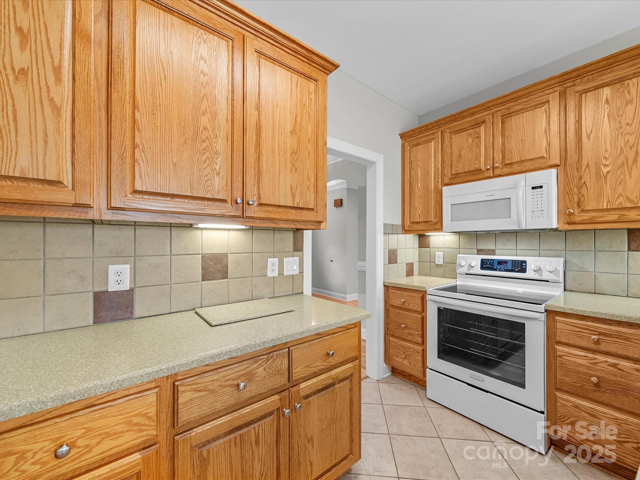 514 Clover Leaf Road Marshville, NC 28103 - Photo 20 of 48 a kitchen with stainless steel appliances granite countertop a stove a sink and a white cabinets