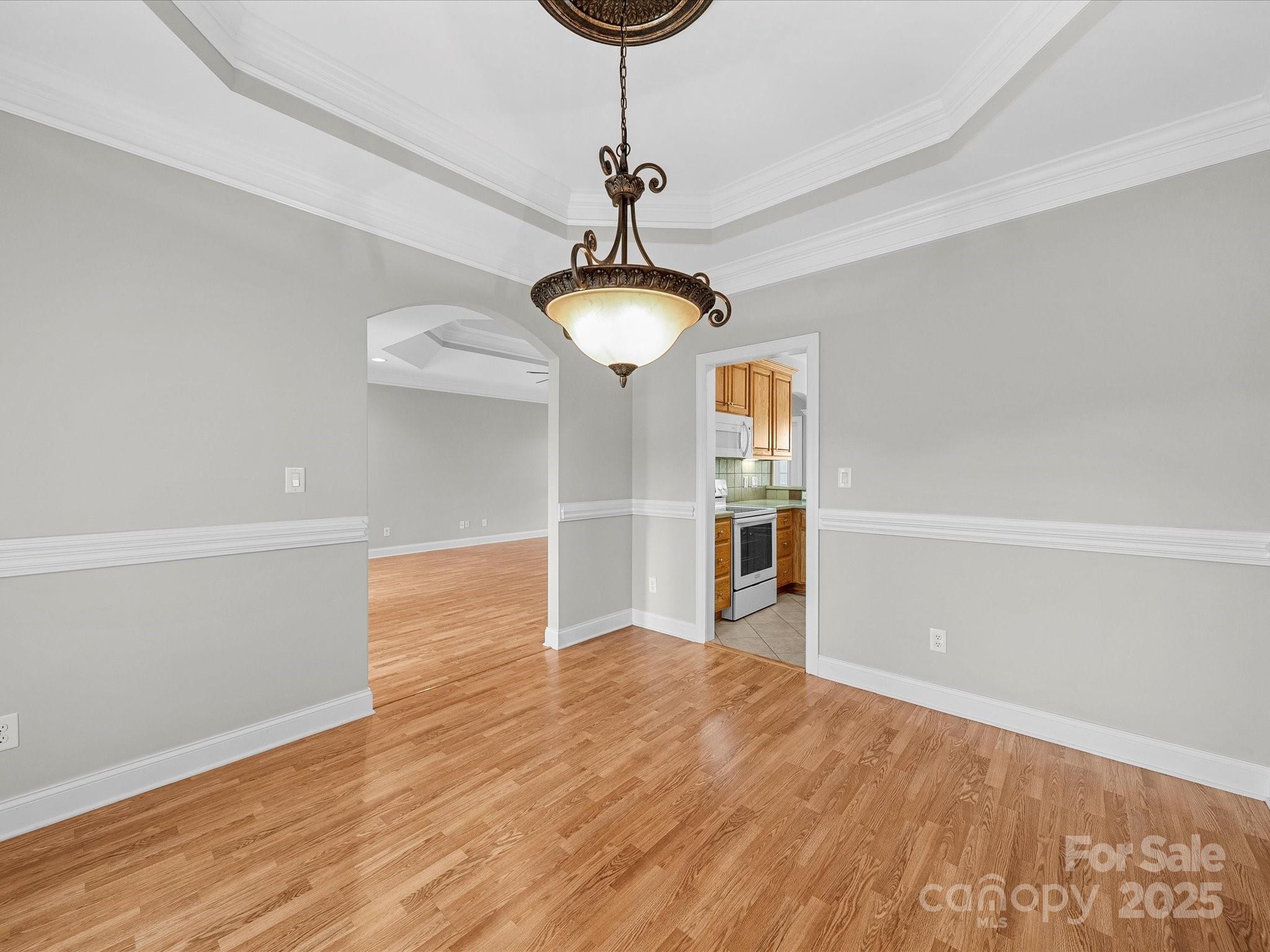 514 Clover Leaf Road Marshville, NC 28103 - Photo 25 of 48 a view of a room with wooden floor and chandelier