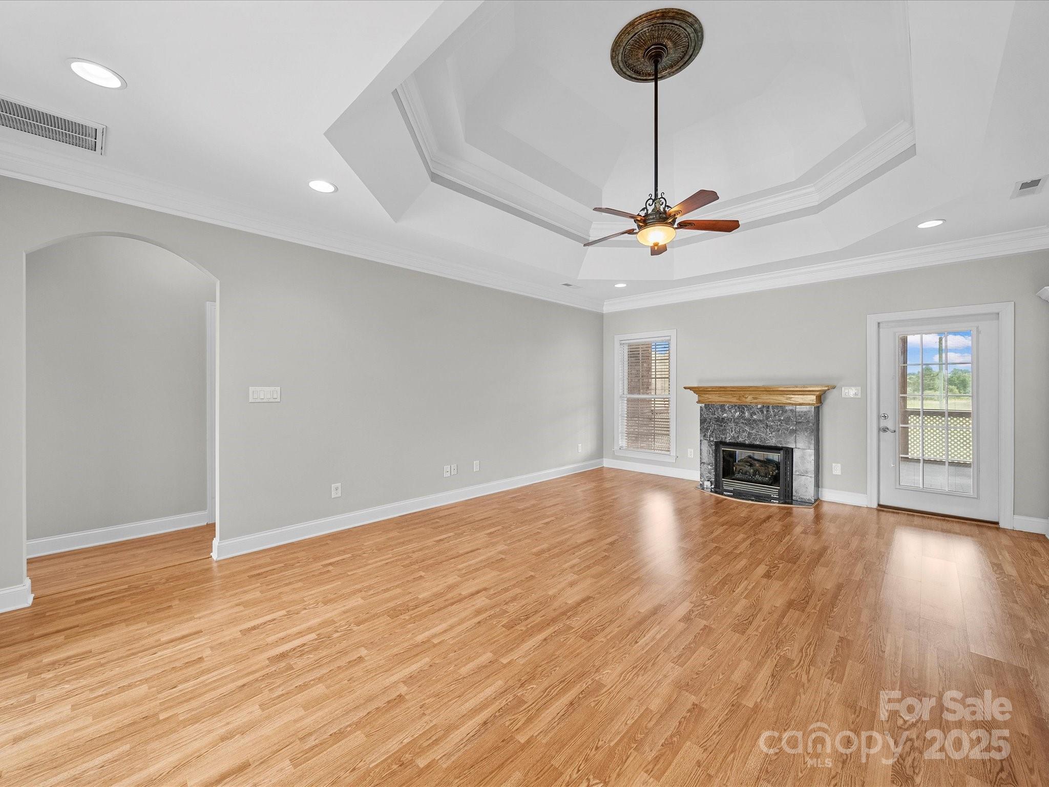 514 Clover Leaf Road Marshville, NC 28103 - Photo 29 of 48 a view of an empty room with wooden floor and a fireplace