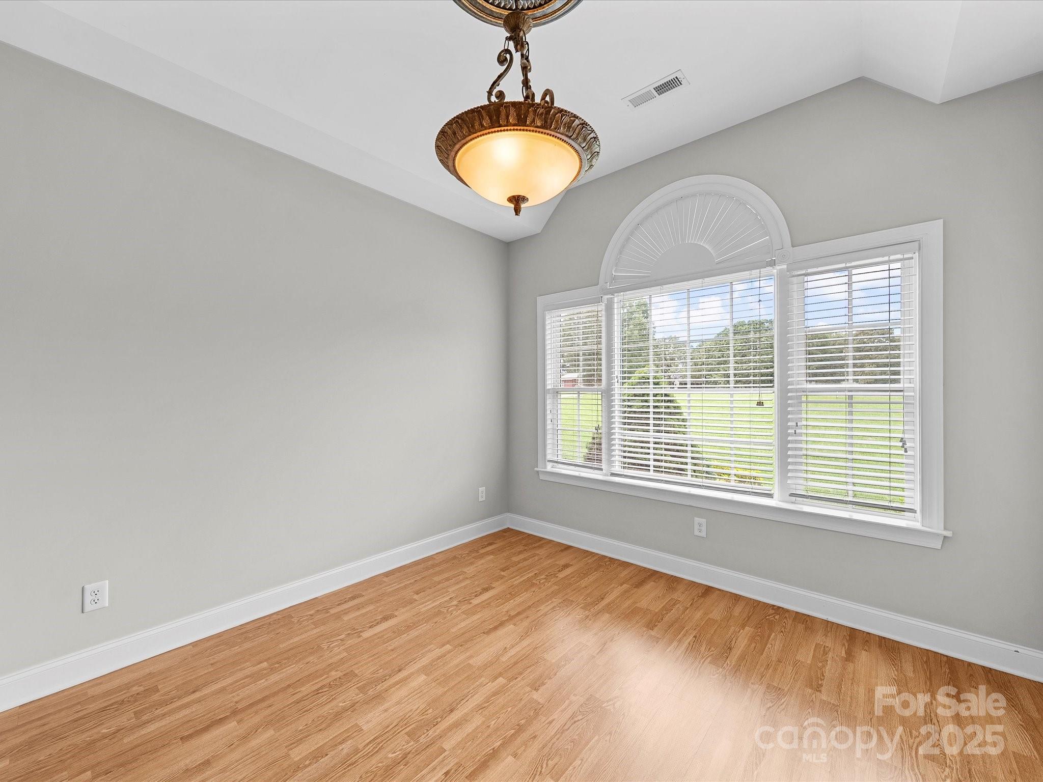 514 Clover Leaf Road Marshville, NC 28103 - Photo 31 of 48 a view of an empty room with wooden floor and a window