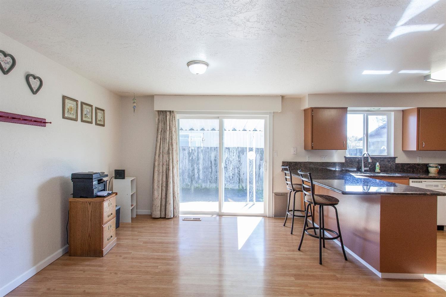 730 Chestnut Street Central Point, OR 97502 - Photo 14 of 23 a view of a dining room with furniture and wooden floor