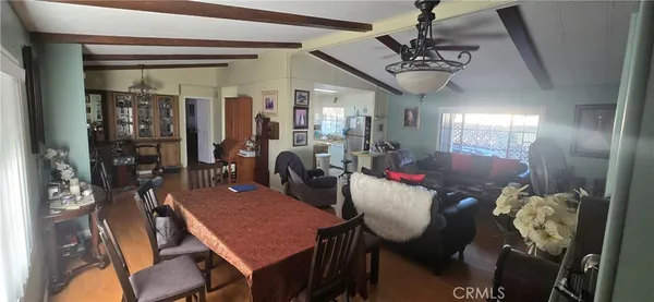 a view of a dining room with furniture and chandelier