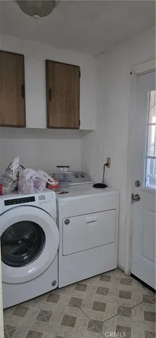 a utility room with sink dryer and washer