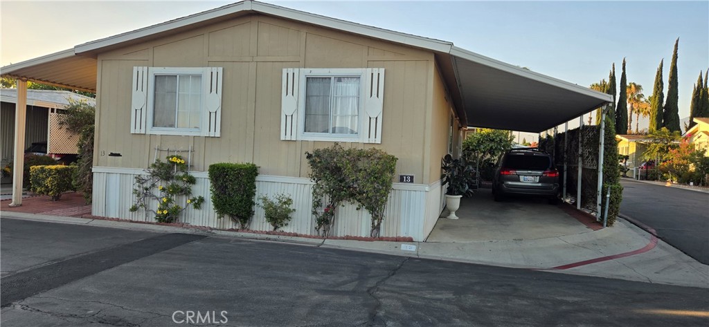 2139 East 4th Street, Unit 13 Ontario, CA 91764 - Photo 2 of 29 a view of a house with a yard