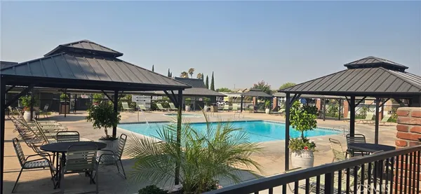 swimming pool view with a seating space