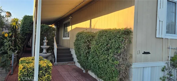 a view of a pathway of a house with a fountain
