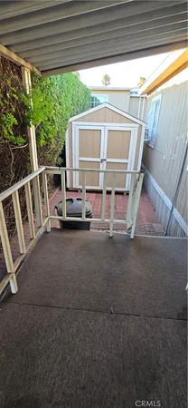 a view of backyard with green space and deck