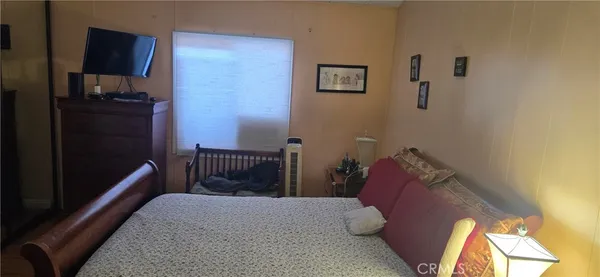 a bedroom with a bed and a lamp