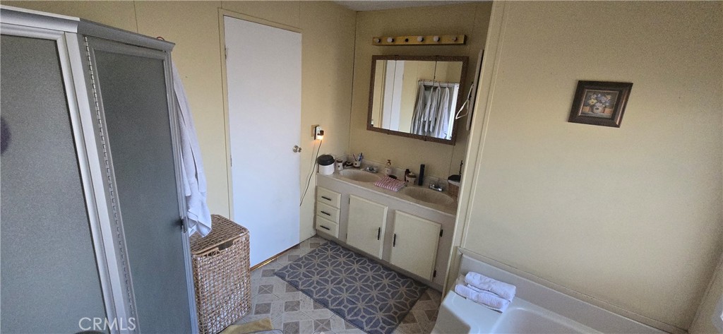 2139 East 4th Street, Unit 13 Ontario, CA 91764 - Photo 10 of 29 a bathroom with a granite countertop sink and a mirror