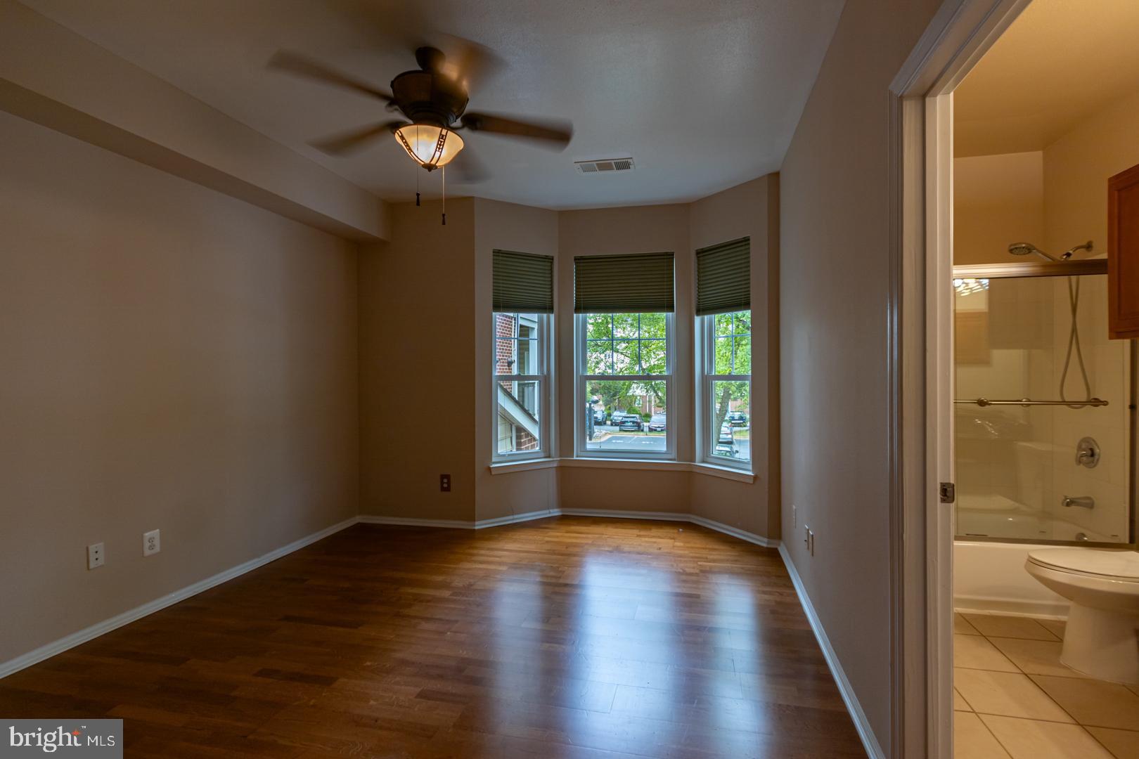 1600 Spring Gate Dr., Unit 2207 McLean, VA 22102 - Photo 15 of 32 wooden floor in an empty room with a window